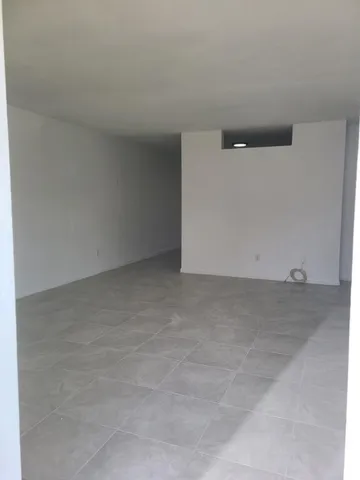 a view of an empty room and a window