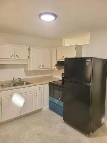 a bathroom with a toilet a sink and bathtub