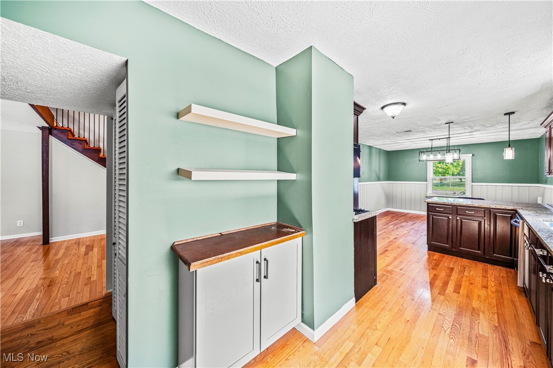 1796 Lander Road Mayfield Heights, OH 44124 - Photo 12 of 39 Kitchen with pendant lighting, a textured ceiling, and light hardwood / wood-style floors