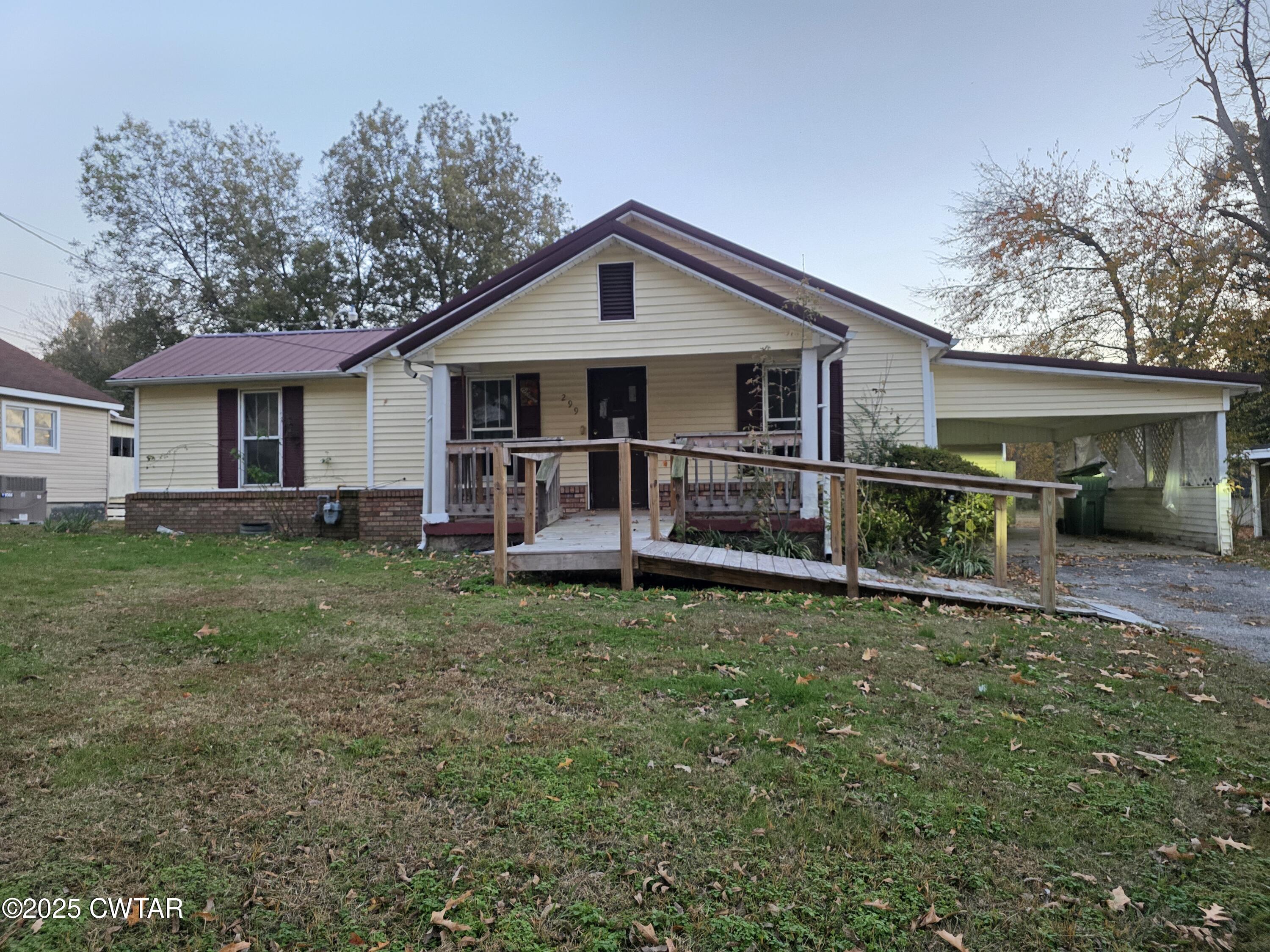 299 East Walnut Street Dyer, TN 38330 - Photo 1 of 41 a view of a house with a yard and sitting area