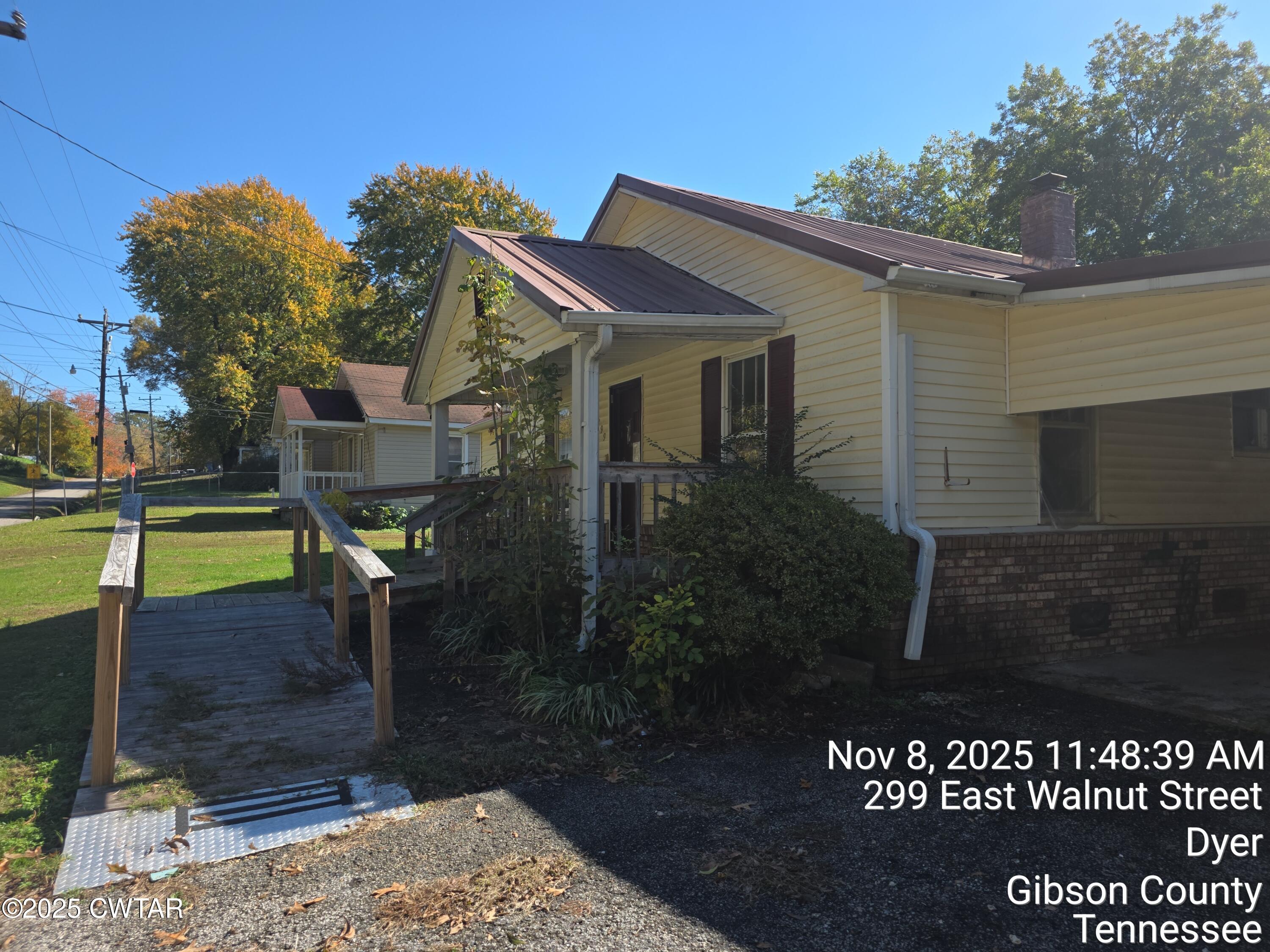 299 East Walnut Street Dyer, TN 38330 - Photo 11 of 41 a front view of a house with a yard
