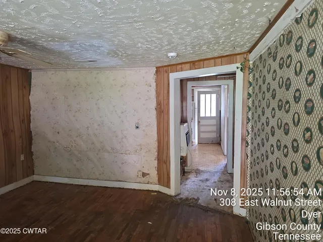 a view of a hallway with a wooden door
