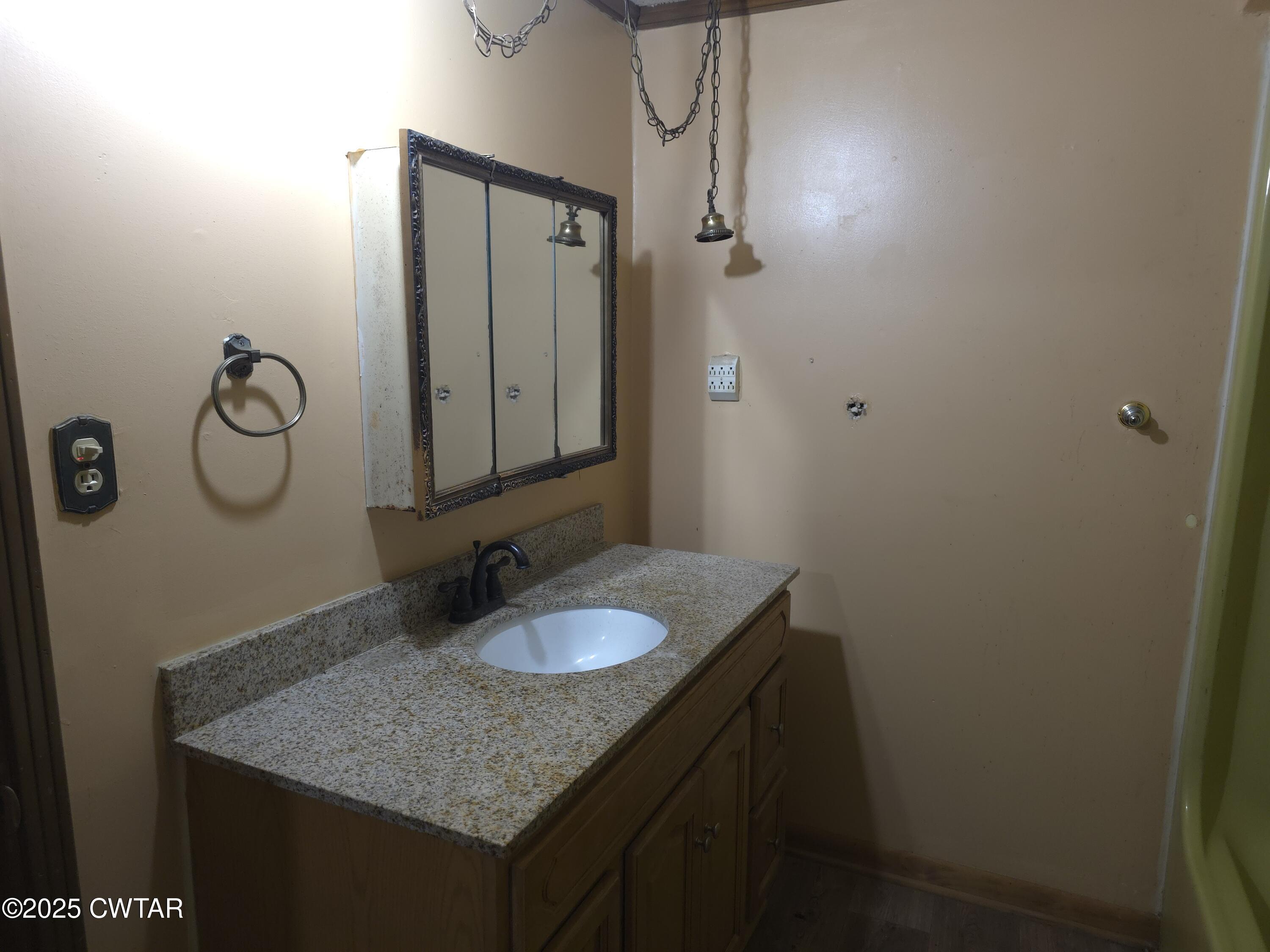 299 East Walnut Street Dyer, TN 38330 - Photo 22 of 41 a bathroom with a granite countertop sink and a mirror