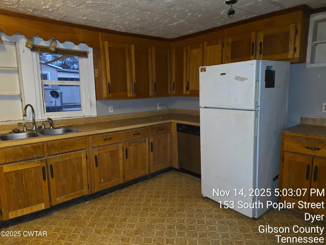 a white refrigerator freezer sitting inside of a kitchen