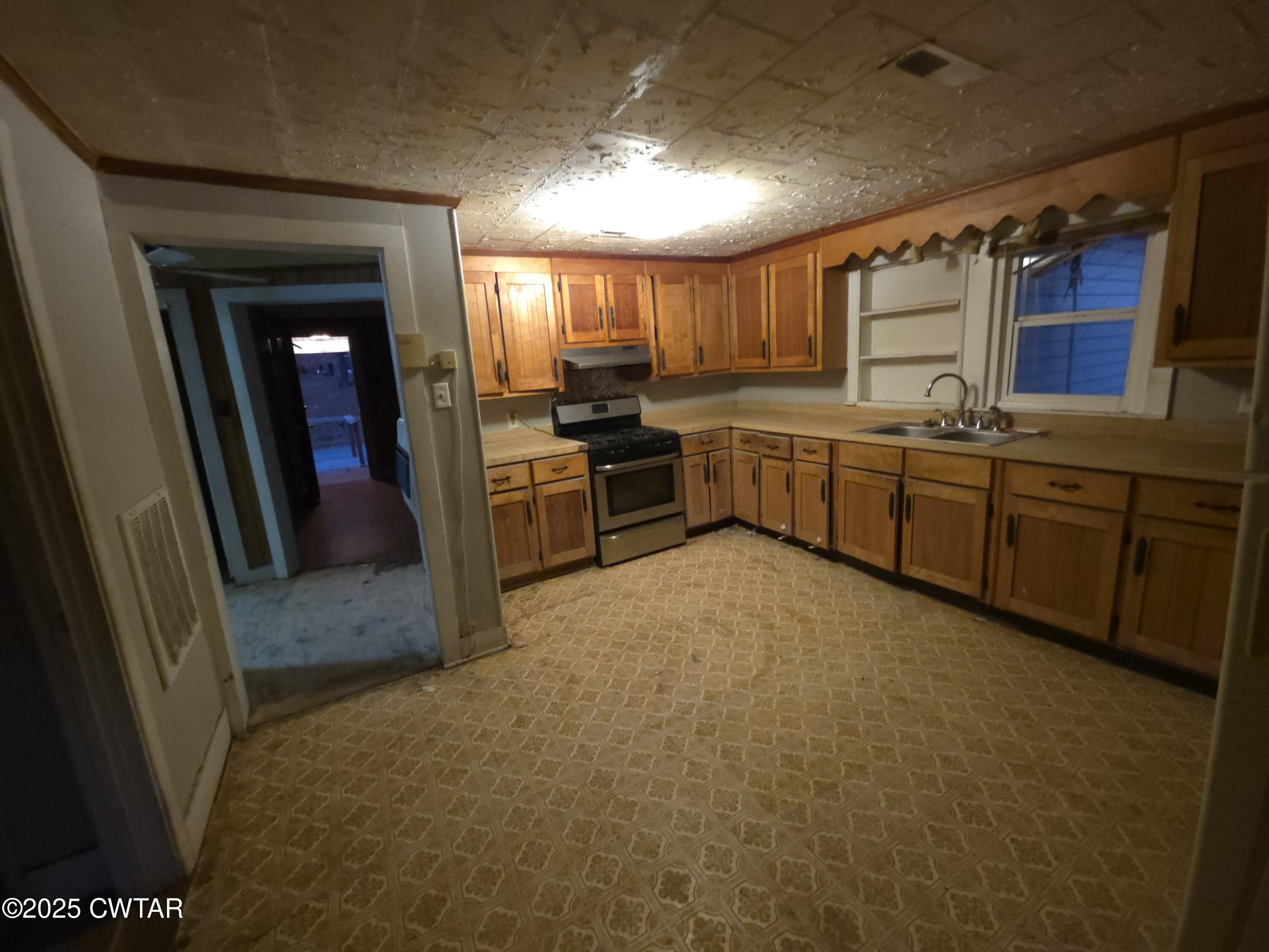 299 East Walnut Street Dyer, TN 38330 - Photo 25 of 41 a large kitchen with a stove a sink and dishwasher