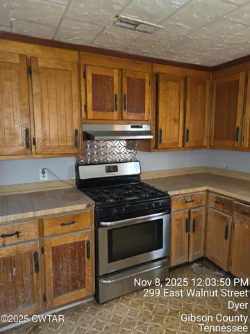 a kitchen with a stove and cabinets