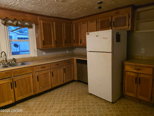 a white refrigerator freezer sitting in a kitchen