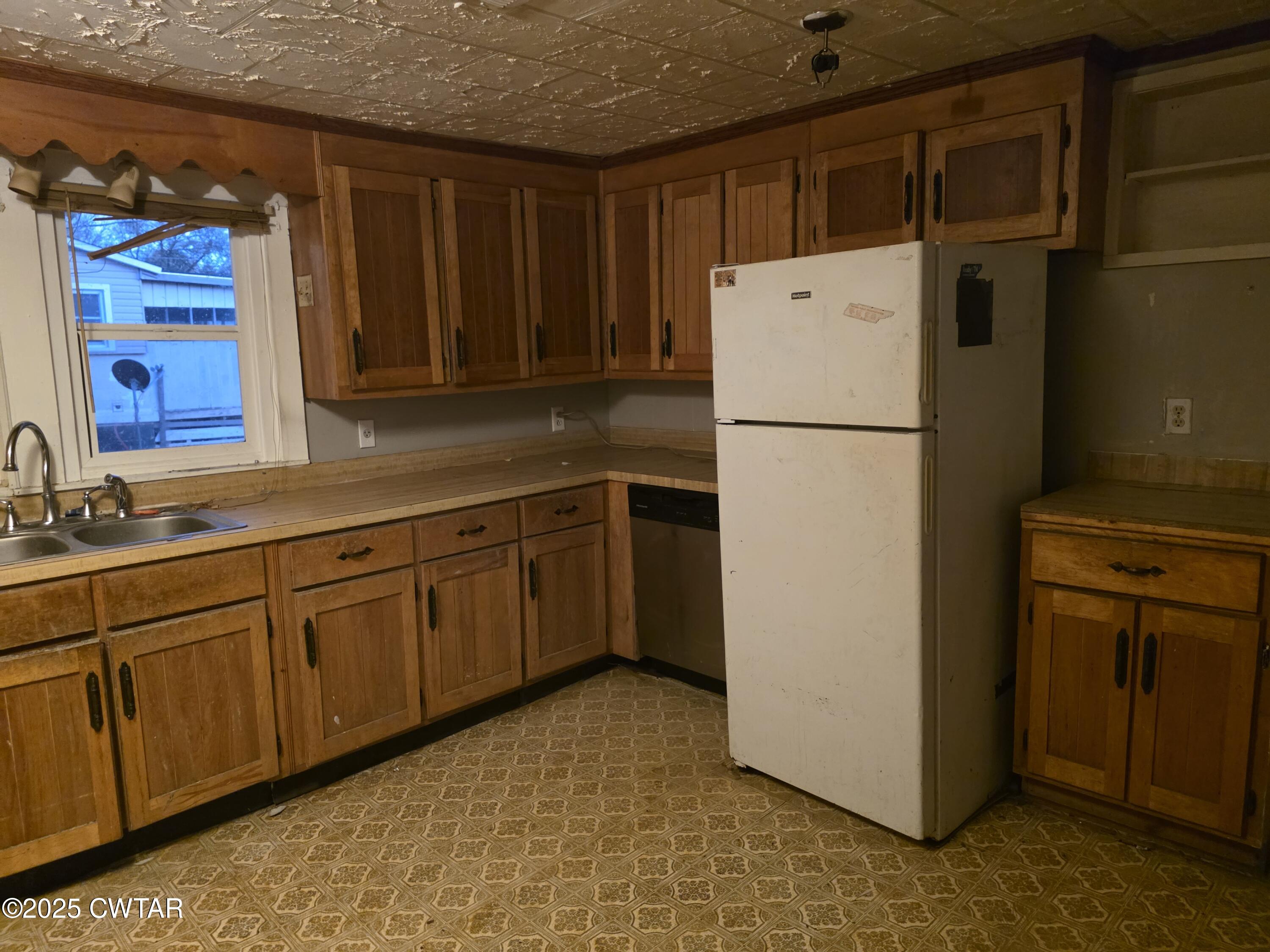 299 East Walnut Street Dyer, TN 38330 - Photo 27 of 41 a white refrigerator freezer sitting in a kitchen