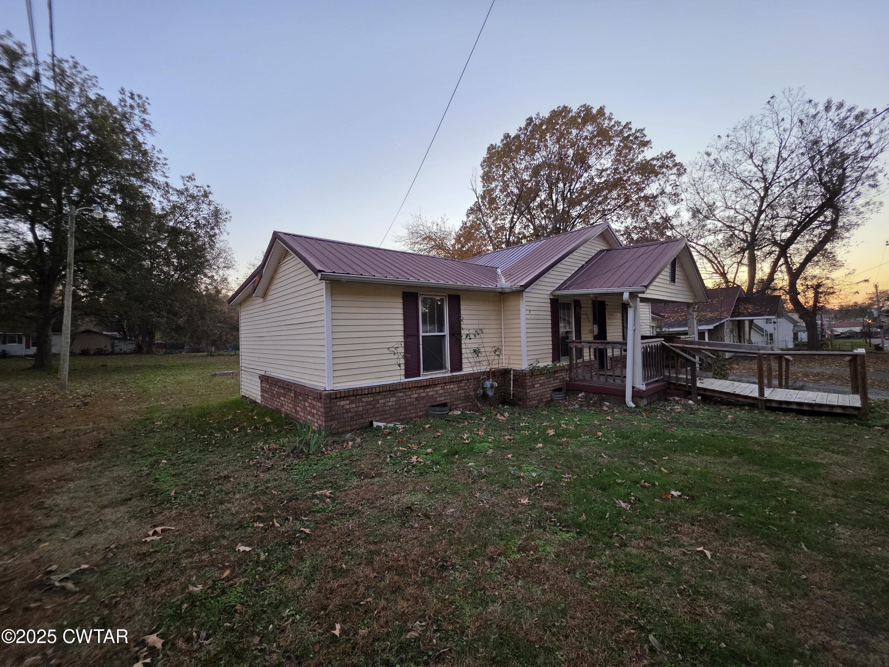 299 East Walnut Street Dyer, TN 38330 - Photo 3 of 41 a view of a house with a yard