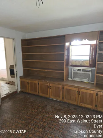 a view of a closet area with wooden floor