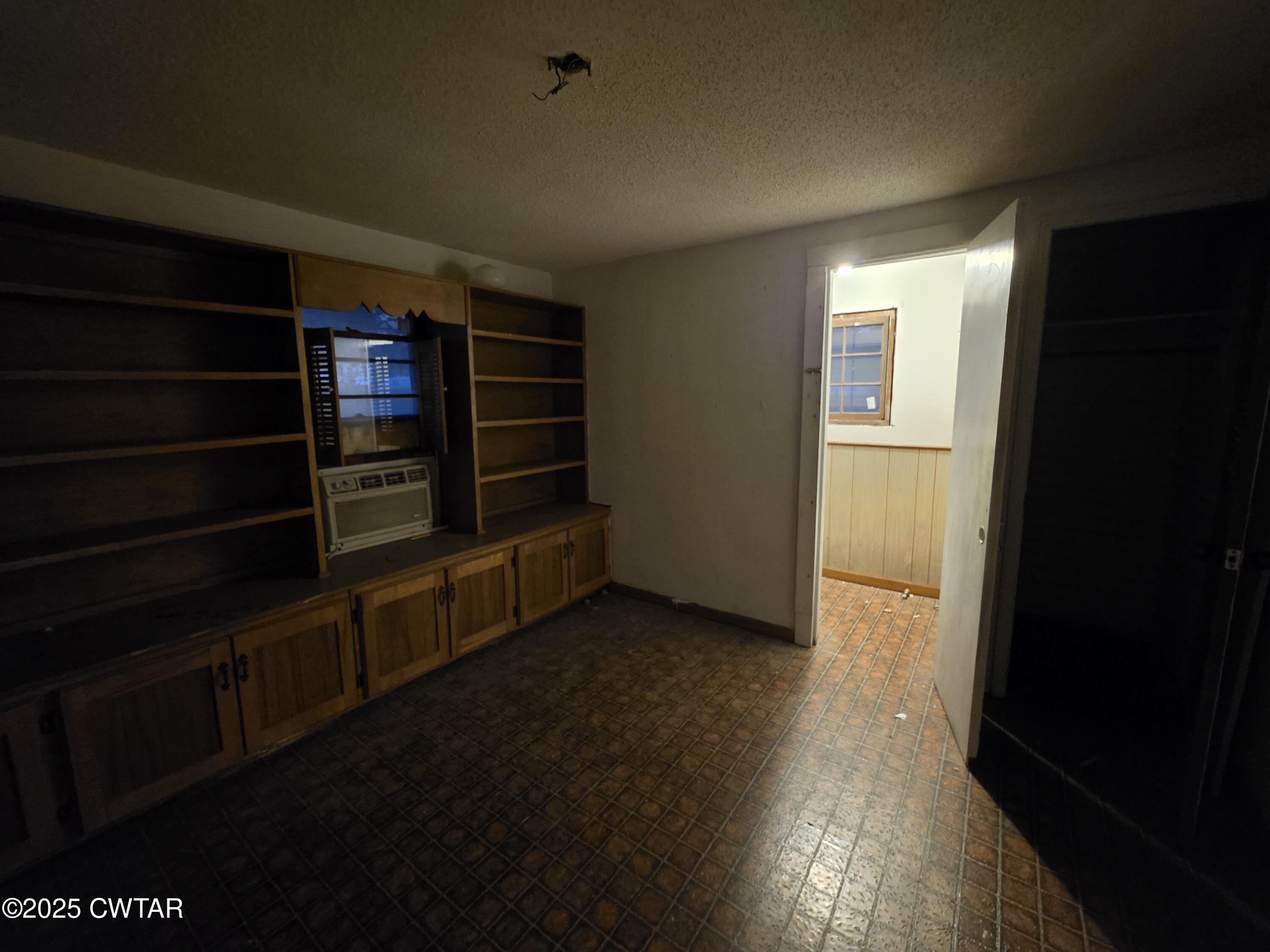 299 East Walnut Street Dyer, TN 38330 - Photo 33 of 41 a view of an empty room with wooden floor and a window