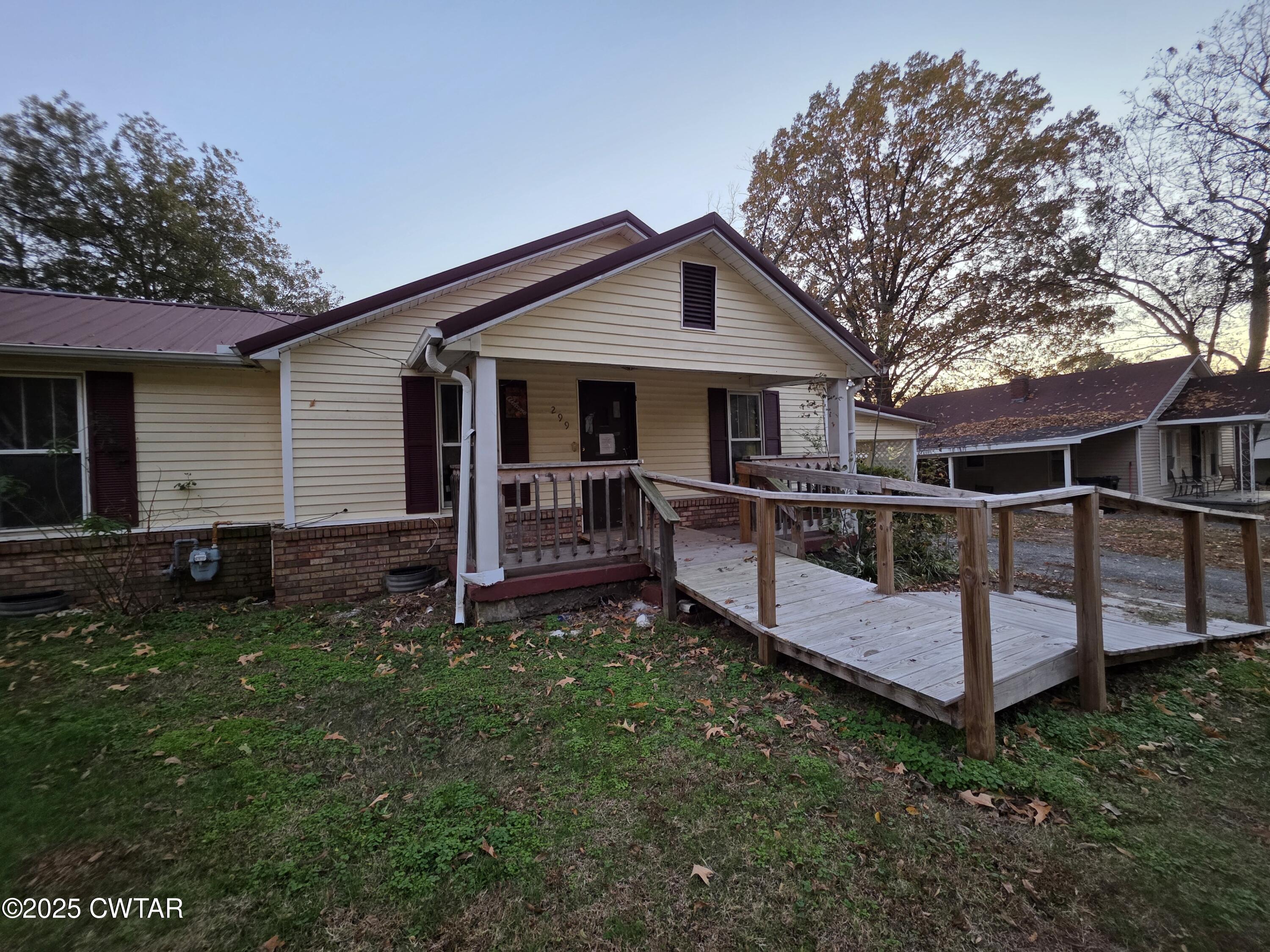 299 East Walnut Street Dyer, TN 38330 - Photo 4 of 41 a view of a house with a yard and deck