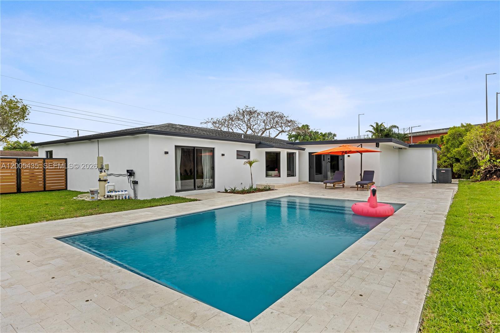 swimming pool view with a seating space