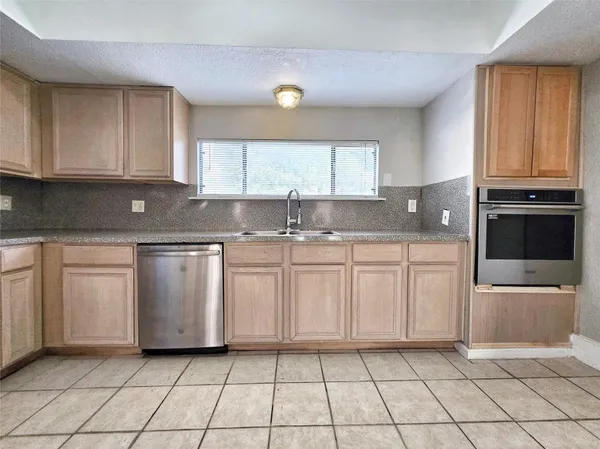 a kitchen with a sink a stove and cabinets
