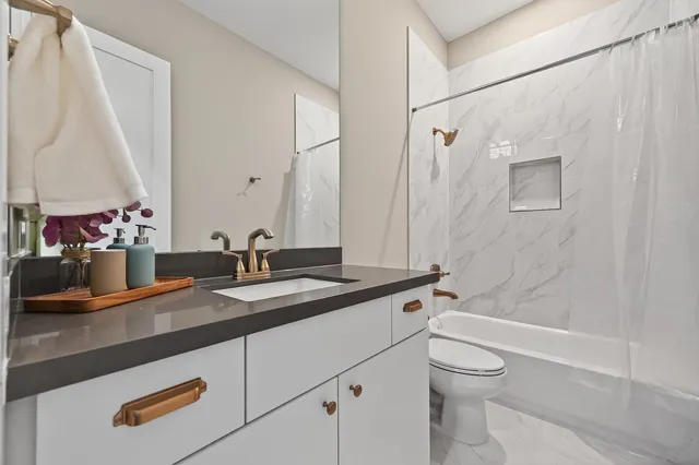 a bedroom with two bed and a view of bedroom