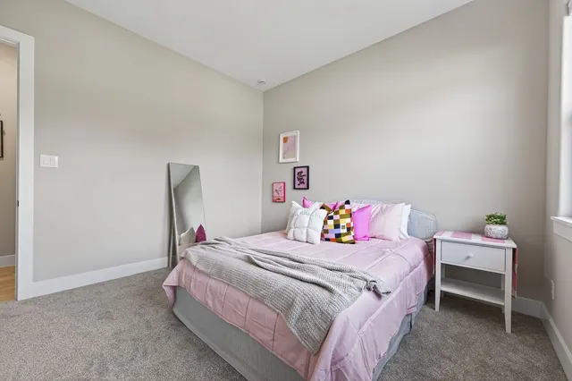 a bathroom with a granite countertop sink a mirror and shower