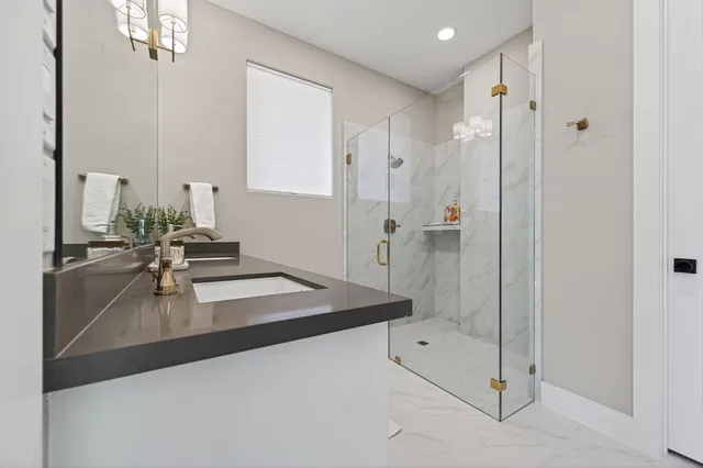 a large kitchen with stainless steel appliances granite countertop a lot of counter space and wooden floors