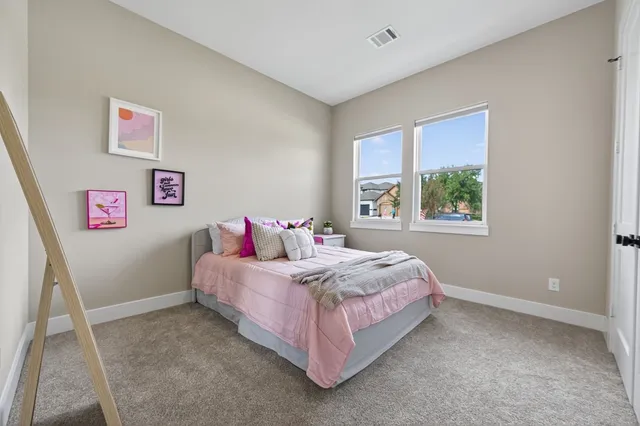 a bedroom with a bed and a potted plant
