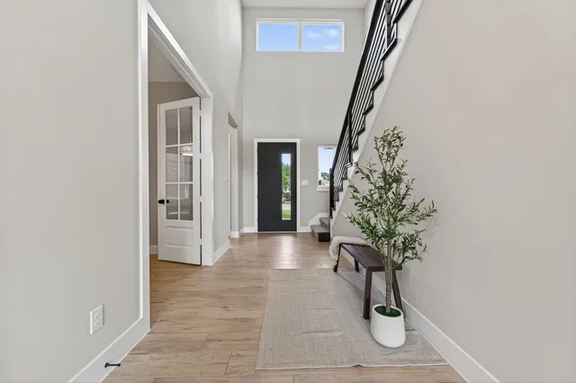 a kitchen with stainless steel appliances kitchen island granite countertop a table chairs microwave and sink