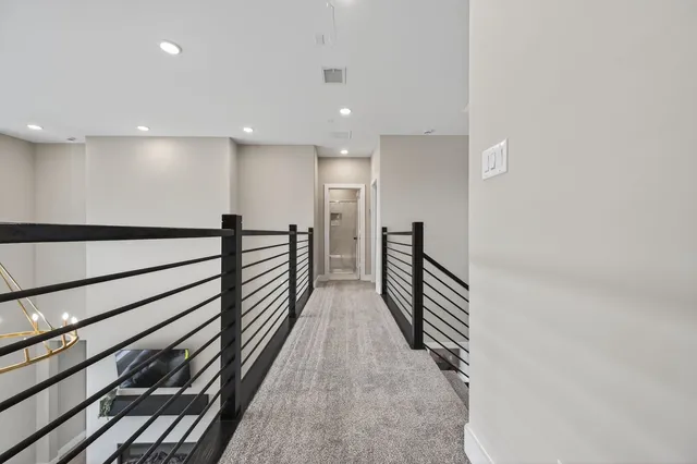 a kitchen with stainless steel appliances granite countertop a table chairs and a refrigerator