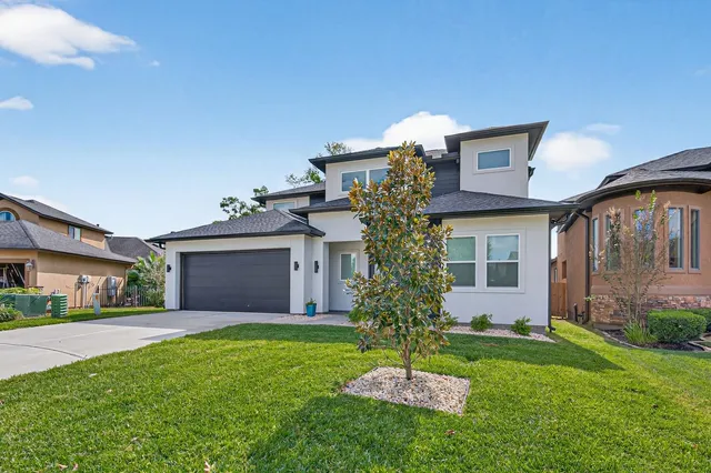 a bathroom with a granite countertop sink toilet a large mirror a shower and a bathtub