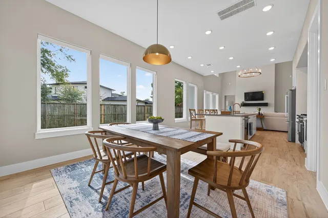 a view of a dining room with furniture wooden floor and chandelier