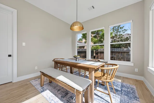 an aerial view of residential houses with outdoor space and lake view