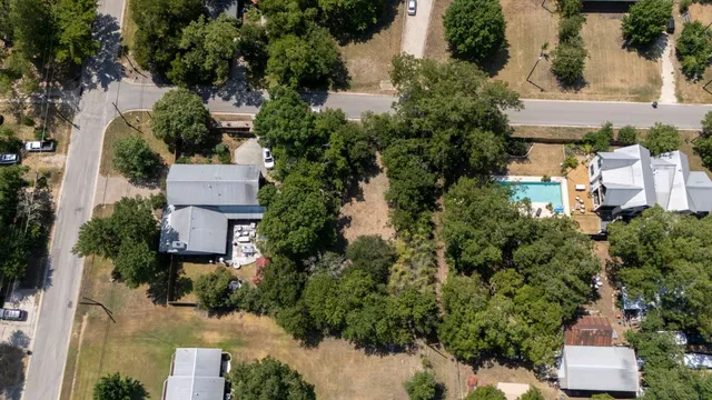 an aerial view of a house with a yard