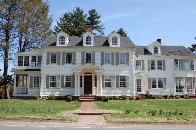 156 Chestnut Hill Road Wilton, CT 06897 - Photo 1 of 1 a front view of a residential apartment building with a yard