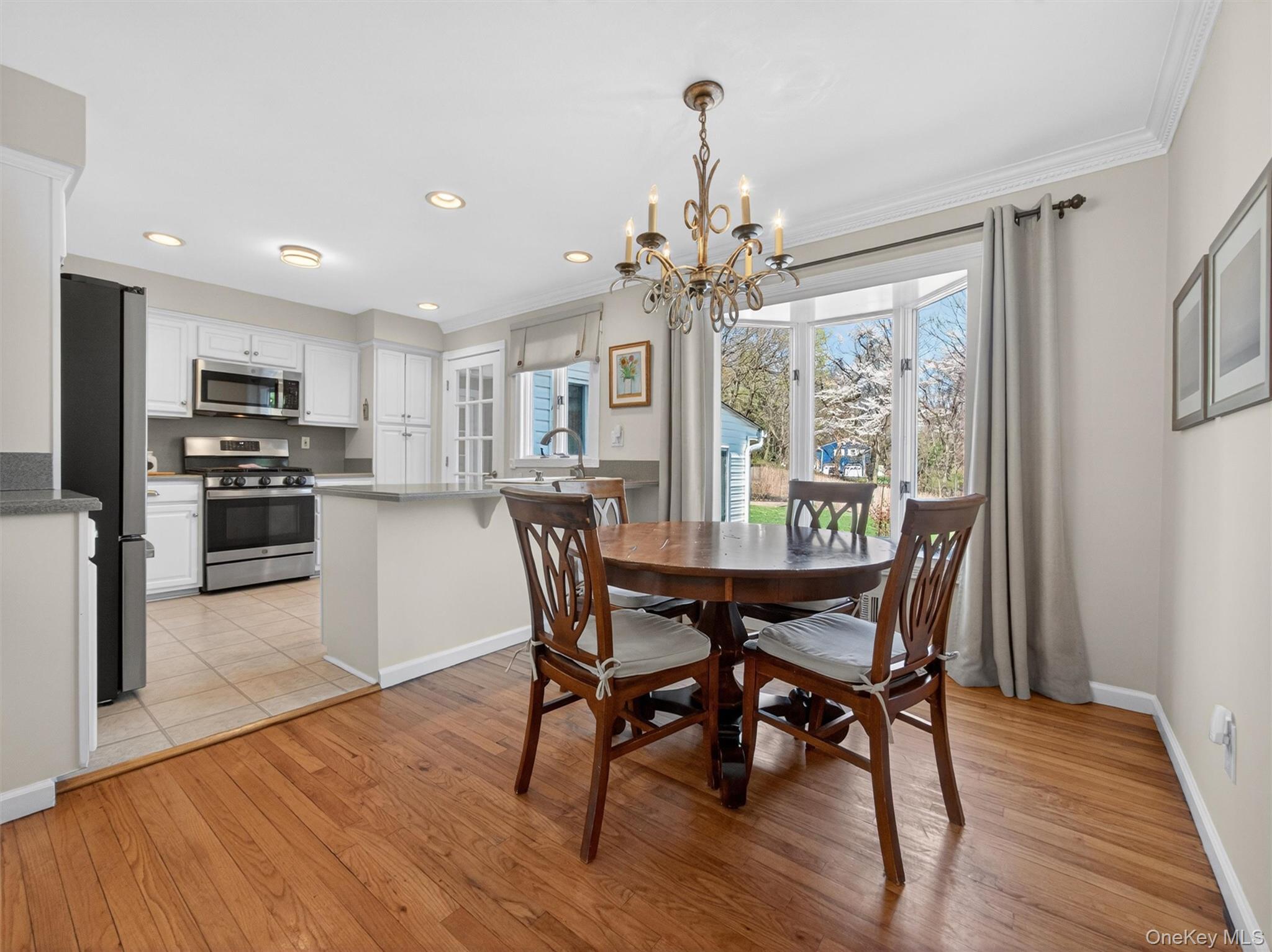 20 Tygert Road Blauvelt, NY 10913 - Photo 10 of 40 Dining space with light wood-type flooring, a chandelier, healthy amount of natural light, and ornamental molding