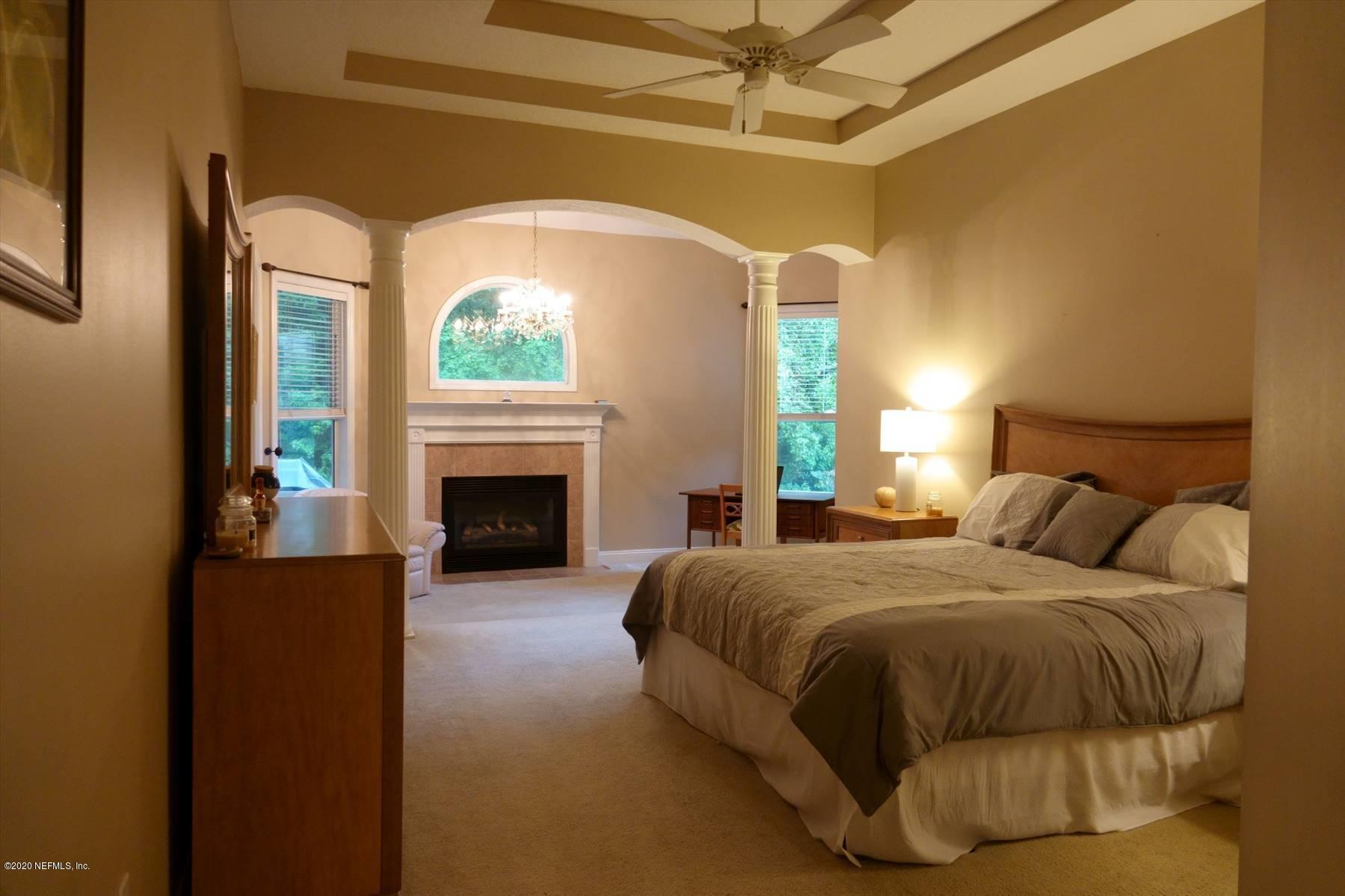 732 Mill Stream Road Ponte Vedra Beach, FL 32082 - Photo 13 of 19 a bedroom with a bed and a fireplace