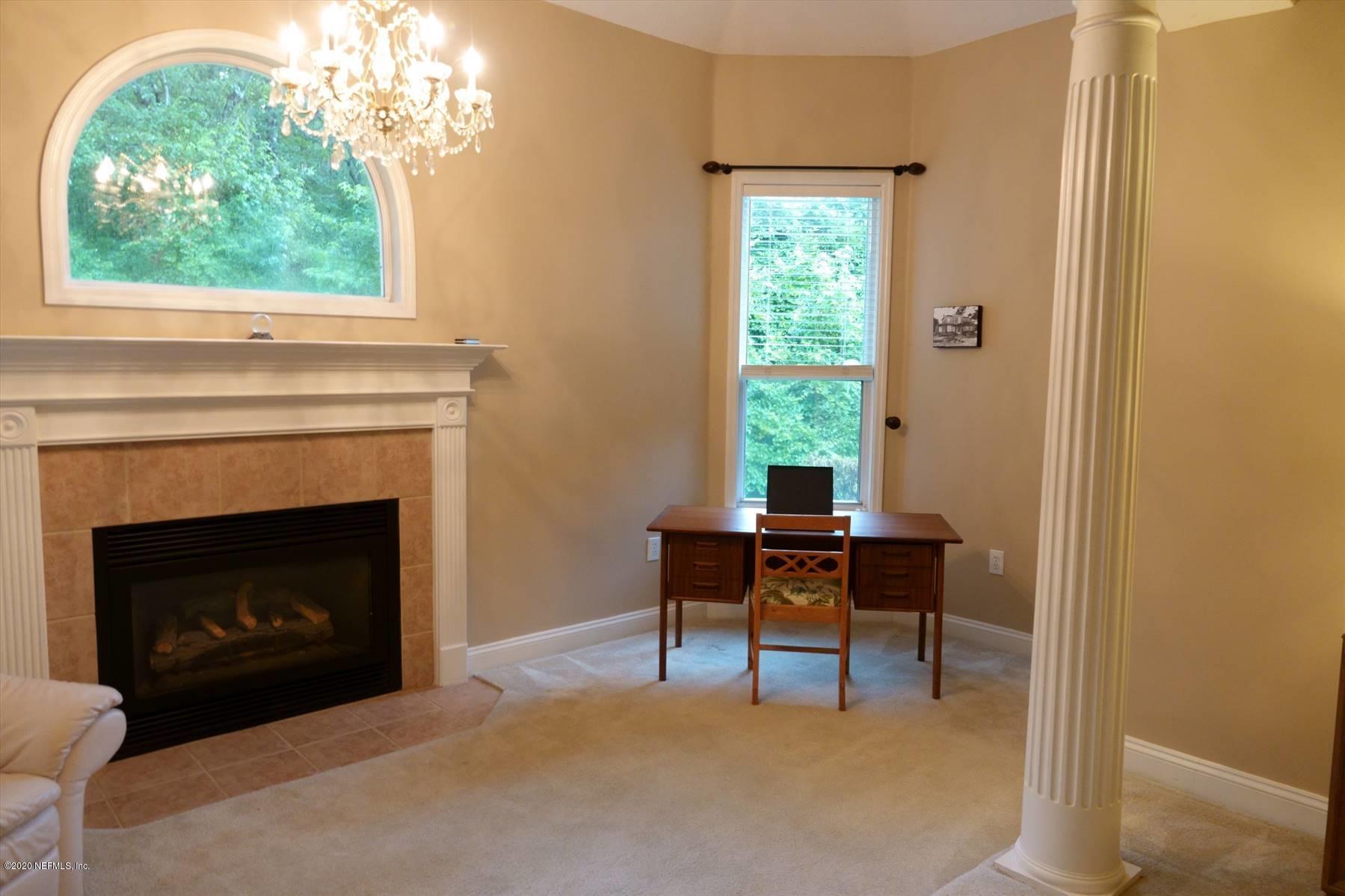 732 Mill Stream Road Ponte Vedra Beach, FL 32082 - Photo 14 of 19 a living room with furniture a fireplace and a window