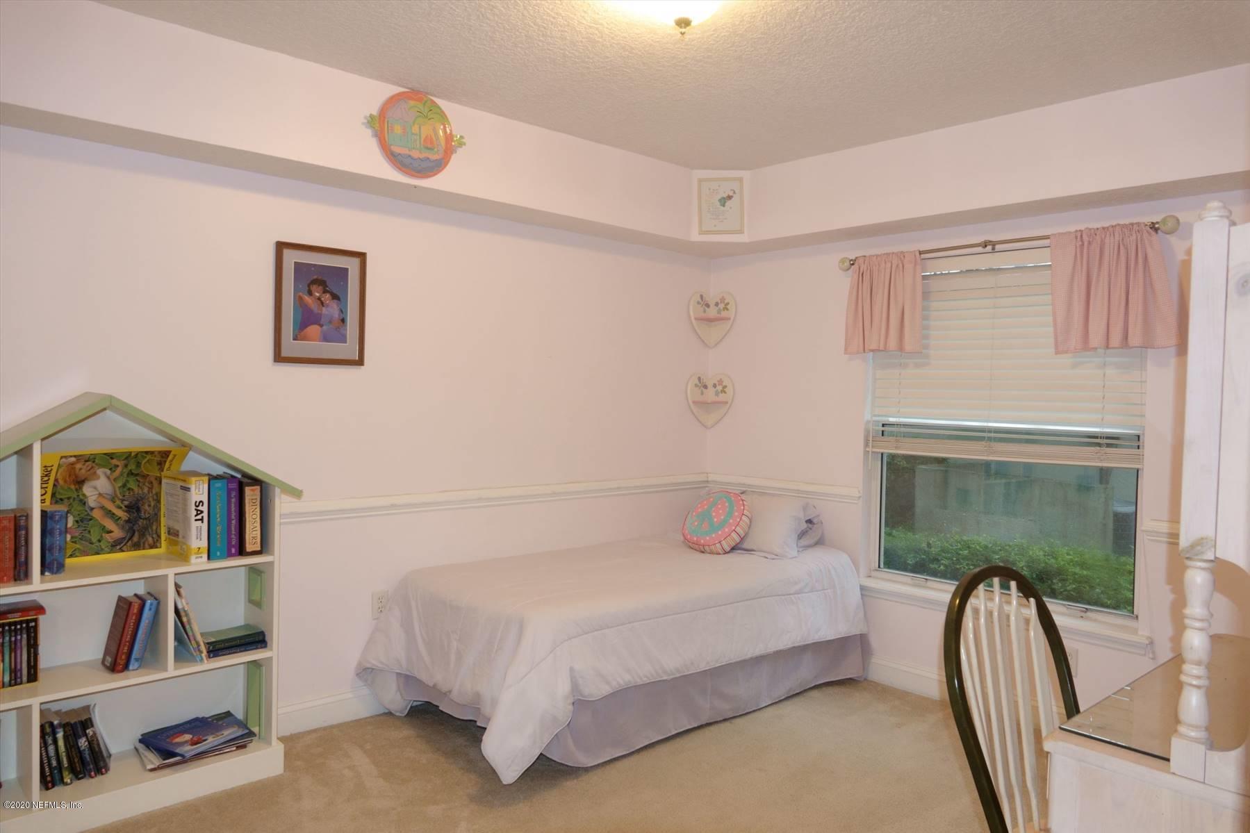 732 Mill Stream Road Ponte Vedra Beach, FL 32082 - Photo 18 of 19 a bedroom with a bed a couch and a large window