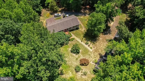 an aerial view of a house with a yard and garden