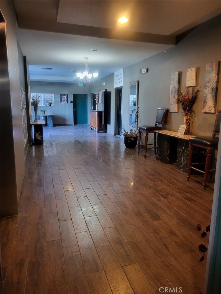 13190 Bromont Avenue, Unit 315 Sylmar, CA 91342 - Photo 4 of 10 a living room with furniture and a wooden floor