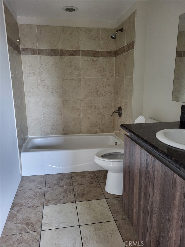 13190 Bromont Avenue, Unit 315 Sylmar, CA 91342 - Photo 10 of 10 a bathroom with a sink a toilet and shower