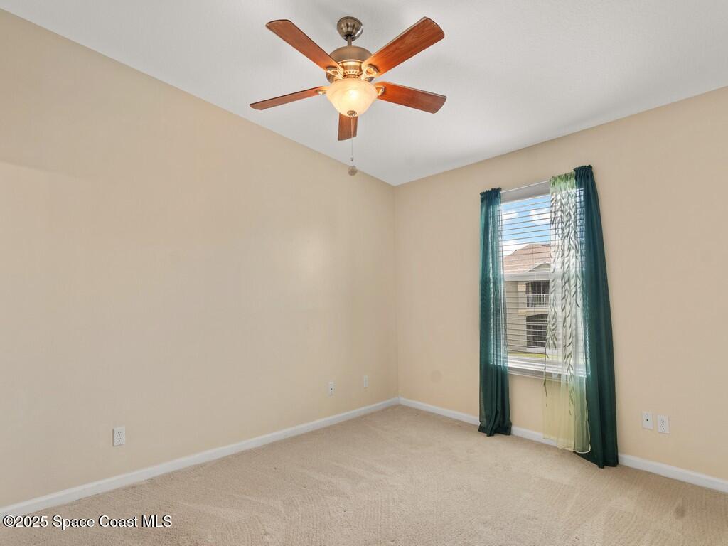 4026 Meander Place, Unit 208 Rockledge, FL 32955 - Photo 14 of 32 an empty room with windows and fan
