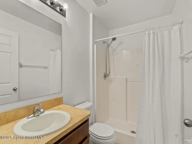 a bathroom with a sink toilet a mirror and shower