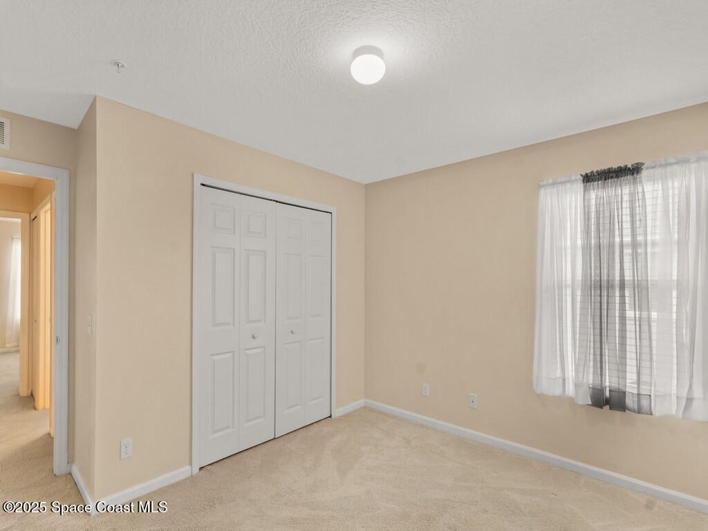 4026 Meander Place, Unit 208 Rockledge, FL 32955 - Photo 19 of 32 an empty room with windows