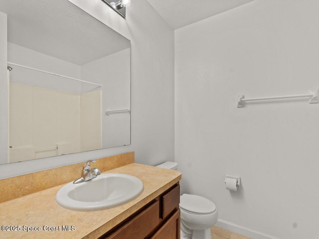 4026 Meander Place, Unit 208 Rockledge, FL 32955 - Photo 22 of 32 a bathroom with a sink toilet and a mirror