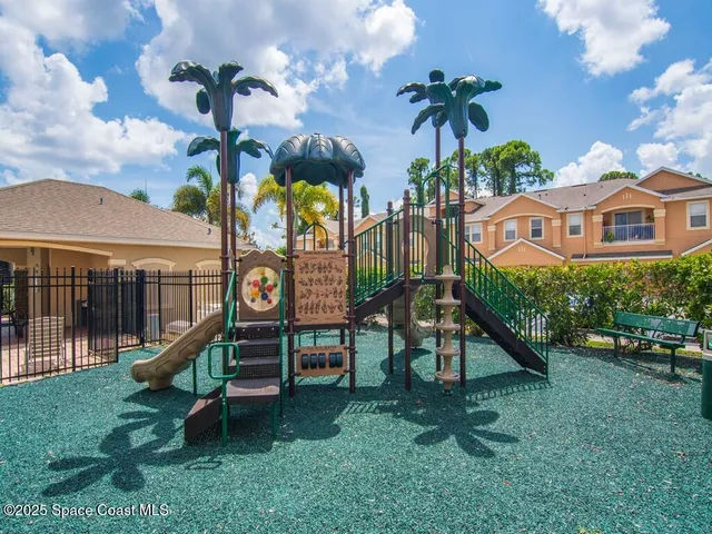a view of a house with a yard and a wooden fence