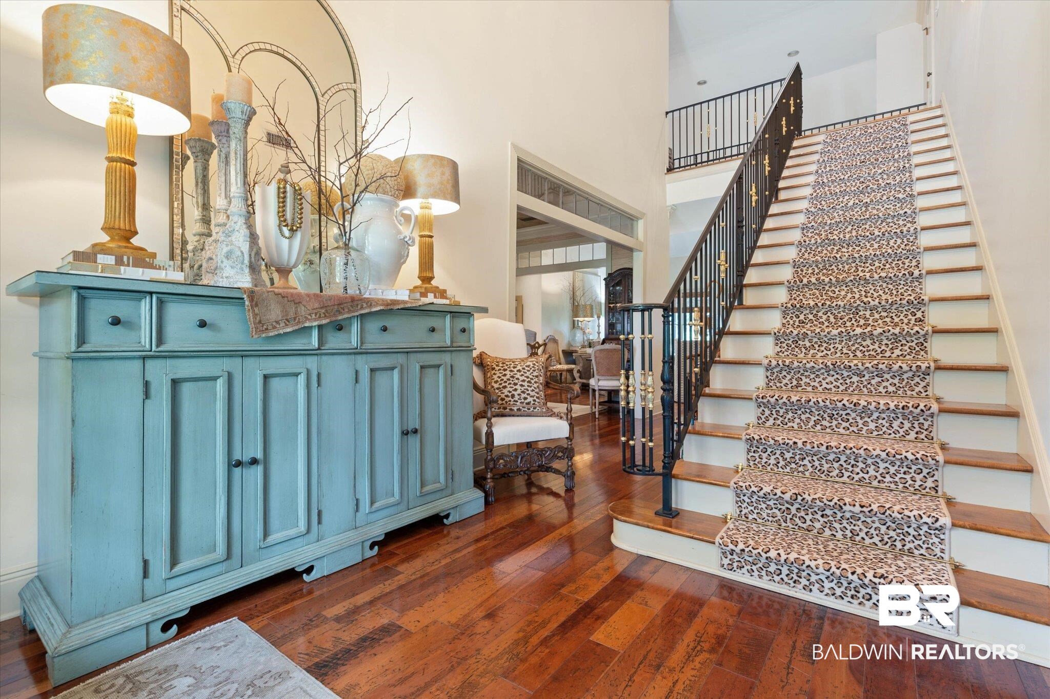 2905 Riverview Pointe Drive South Theodore, AL 36582 - Photo 2 of 44 Staircase with a high ceiling and hardwood / wood-style floors