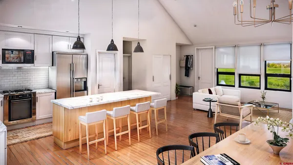 a kitchen with stainless steel appliances kitchen island granite countertop a stove a refrigerator a dining table and chairs with wooden floor