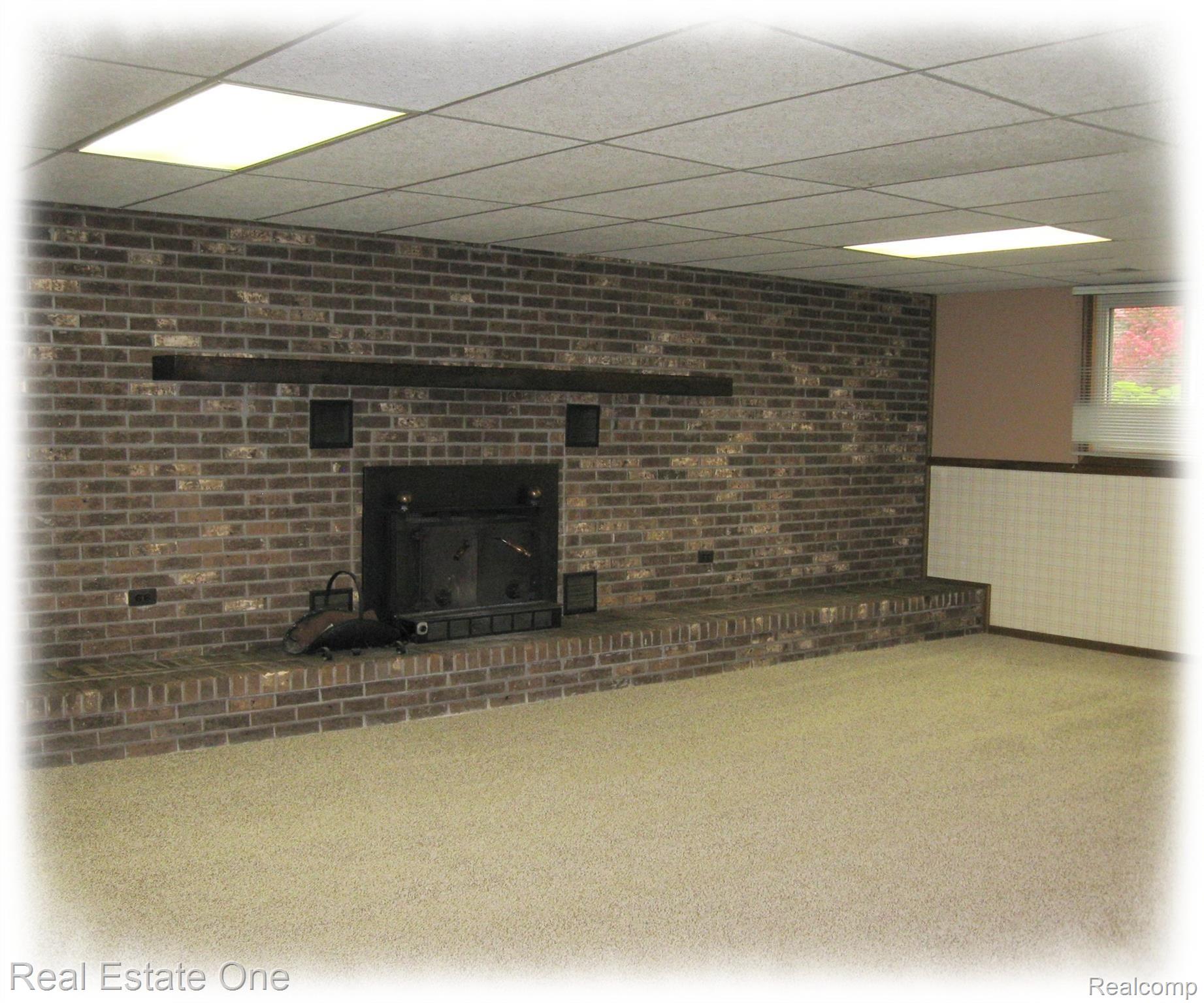 40425 Willis Road Belleville, MI 48111 - Photo 17 of 36 Family Room with full wall fireplace and access to garage