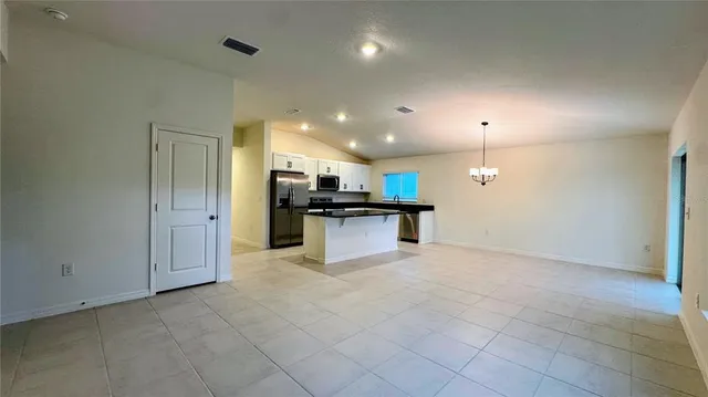 a view of kitchen with refrigerator sink and stove