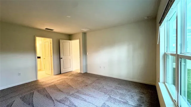 an empty room with windows and closet