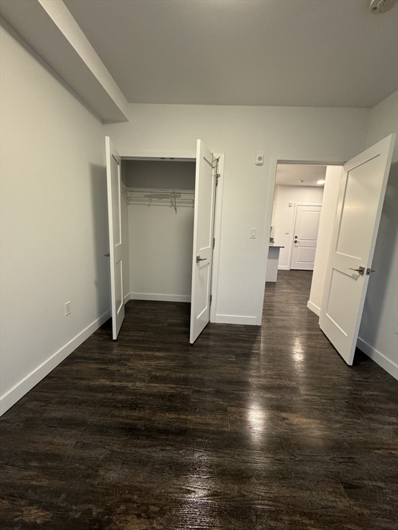 6 Needhams Landing Road, Unit 206 Lynn, MA 01905 - Photo 3 of 12 a view of a room with wooden floor and a kitchen