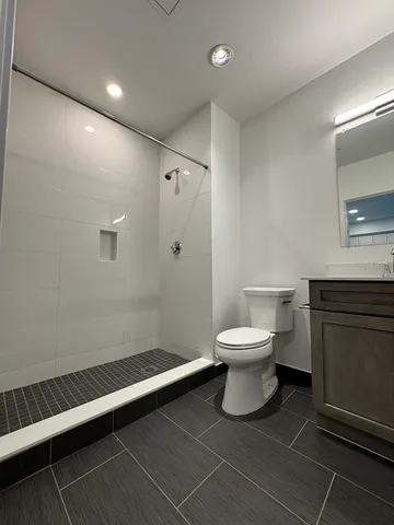 a bathroom with a toilet a sink and mirror