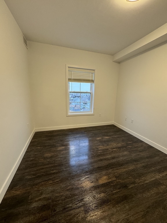 6 Needhams Landing Road, Unit 206 Lynn, MA 01905 - Photo 8 of 12 a view of an empty room with wooden floor and a window