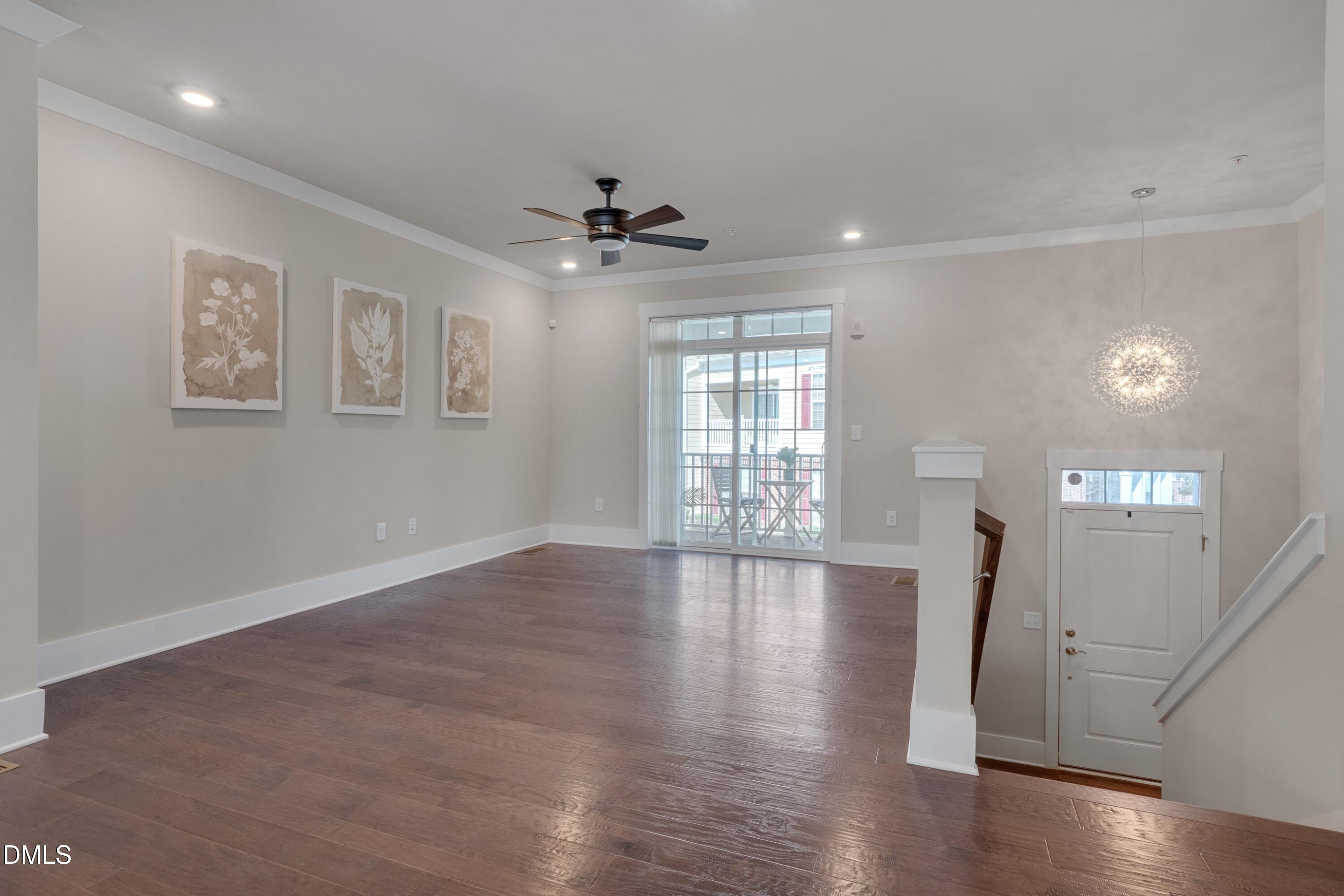 10330 Sablewood Drive, Unit 104 Raleigh, NC 27617 - Photo 8 of 39 a view of an empty room with wooden floor and a window